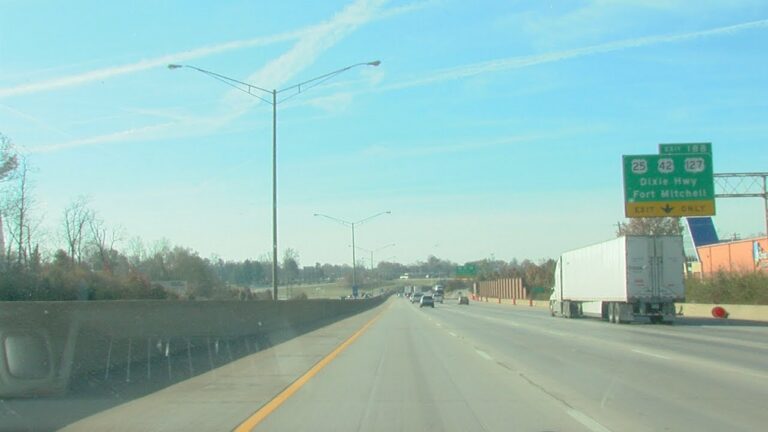 high way in the day time with street lights. semi and cars driving