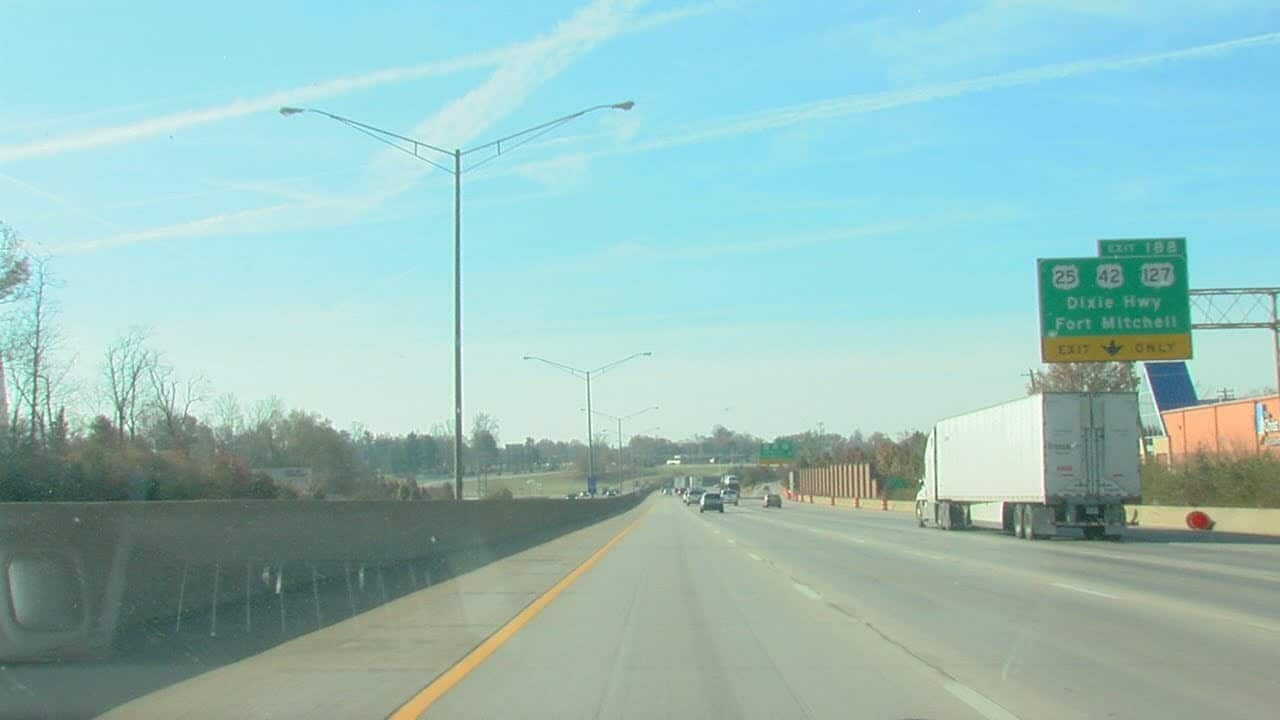 high way in the day time with street lights. semi and cars driving